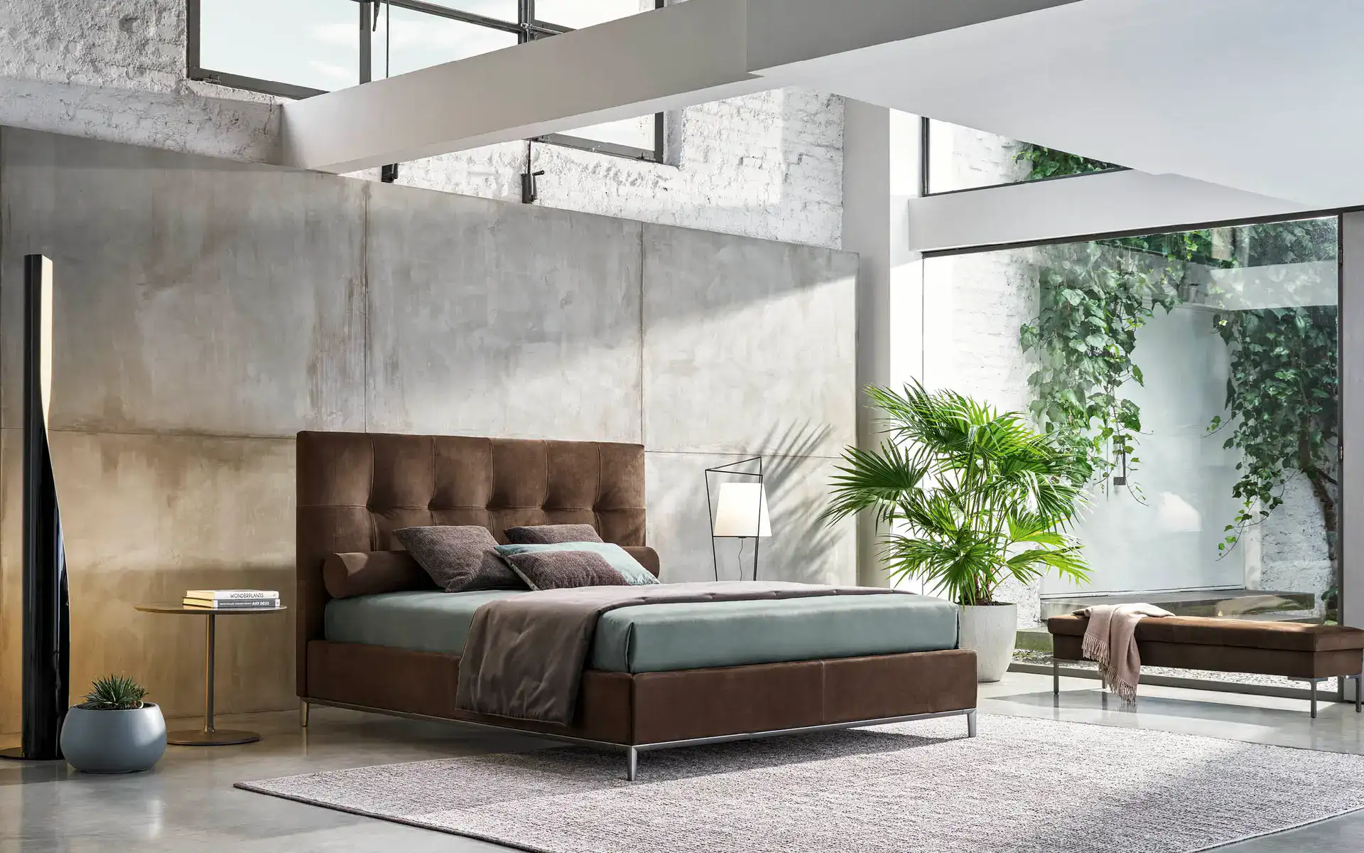 Lampada a sospensione moderna in stile industriale nella camera da letto con pareti in cemento.